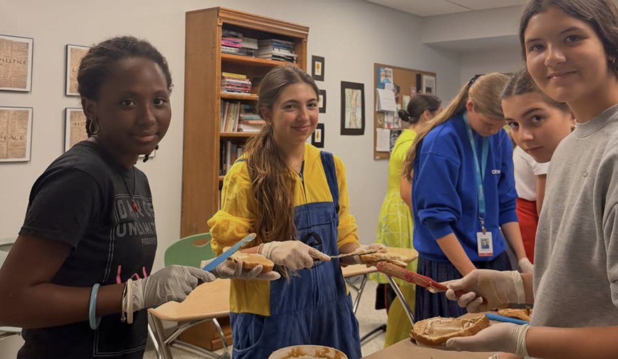 Students spreading peanut butter together